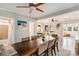 Open dining room with a large wooden table, modern decor, and seamless access to the living area at 504 W Ashley Ave, Folly Beach, SC 29439