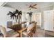 Inviting dining room with seating for six, a ceiling fan, and modern decor on the accent wall at 504 W Ashley Ave, Folly Beach, SC 29439