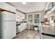 Bright kitchen with stainless steel appliances, laminate floors, and a view of the yard at 504 W Ashley Ave, Folly Beach, SC 29439