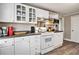 Efficient kitchen with white cabinetry, stainless steel appliances and gray countertop at 504 W Ashley Ave, Folly Beach, SC 29439