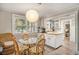 Bright breakfast nook with round glass table, wicker chairs, and natural light from large windows at 504 W Ashley Ave, Folly Beach, SC 29439
