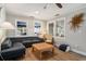 Cozy living room with a comfortable sofa, woven coffee table, and bright natural lighting at 504 W Ashley Ave, Folly Beach, SC 29439
