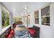 Cozy covered porch with comfortable seating, decorative rugs, and access to a landscaped area at 504 W Ashley Ave, Folly Beach, SC 29439