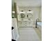 Stylish bathroom featuring dual sinks, modern lighting, and a sleek, freestanding bathtub at 5079 Coral Reef Dr, Johns Island, SC 29455