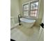 Bright bathroom featuring a modern freestanding tub and natural light from a nearby window at 5079 Coral Reef Dr, Johns Island, SC 29455