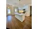 Open-concept kitchen featuring a large island, modern appliances, and a seamless flow to the living area at 5079 Coral Reef Dr, Johns Island, SC 29455
