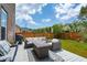 A spacious back deck featuring outdoor seating, a fire table, and a well-manicured lawn at 525 Yellow Tower Ter, Charleston, SC 29412