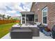 Back deck with outdoor seating, landscaping, and access to a screened-in porch in a well-manicured yard at 525 Yellow Tower Ter, Charleston, SC 29412