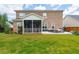 An expansive backyard features a screened-in porch, patio furniture, and lush green grass at 525 Yellow Tower Ter, Charleston, SC 29412