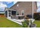 Backyard view featuring a patio, a screened porch, lush green grass, and manicured landscaping at 525 Yellow Tower Ter, Charleston, SC 29412