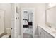 Bathroom view into bedroom featuring white cabinets, stone countertop, and modern fixtures at 525 Yellow Tower Ter, Charleston, SC 29412