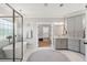 Bright bathroom with a glass-enclosed shower, freestanding tub, and gray cabinetry with marble countertops at 525 Yellow Tower Ter, Charleston, SC 29412