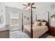 Bedroom with four-poster bed, neutral bedding, carpeted floor, and bright window at 525 Yellow Tower Ter, Charleston, SC 29412