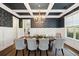 Formal dining room featuring wainscoting, stylish wallpaper, coffered ceiling, and chandelier at 525 Yellow Tower Ter, Charleston, SC 29412