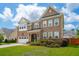 Beautiful two-story brick home boasting lush landscaping and a driveway with attached two car garage at 525 Yellow Tower Ter, Charleston, SC 29412