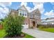 Beautiful brick home with a well-manicured lawn, arched entryway, and a two-car garage at 525 Yellow Tower Ter, Charleston, SC 29412