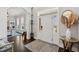 Welcoming foyer featuring hardwood floors, a stylish rug, and a bright entryway with a white front door at 525 Yellow Tower Ter, Charleston, SC 29412