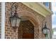 A well lit front porch showing the brick design with two dark lamps, and the house number at 525 Yellow Tower Ter, Charleston, SC 29412