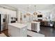 Open-concept kitchen with stainless steel appliances, a center island, and pendant lighting over dark wood floors at 525 Yellow Tower Ter, Charleston, SC 29412