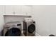 Modern laundry room with gray front load washing machine and white cabinets at 525 Yellow Tower Ter, Charleston, SC 29412