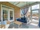 Cozy screened porch featuring a daybed swing, casual seating, and a decorative brick wall at 525 Yellow Tower Ter, Charleston, SC 29412