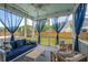 Relaxing screened porch featuring a daybed swing, comfortable seating, and blue patterned rug at 525 Yellow Tower Ter, Charleston, SC 29412