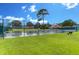 Community tennis court surrounded by green grass and trees on a bright, sunny day at 525 Yellow Tower Ter, Charleston, SC 29412