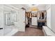 Spacious walk-in closet features custom shelving, plentiful hanging space, and access to a luxurious bathroom with a soaking tub and glass shower at 525 Yellow Tower Ter, Charleston, SC 29412
