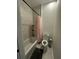 Bathroom with white tile shower and floral shower curtain, complemented by a toilet and dark bath mat at 5681 Captain Kidd Rd, Hollywood, SC 29449