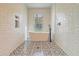 Modern bathroom with freestanding tub, patterned floor tiles, and stylish fixtures at 5681 Captain Kidd Rd, Hollywood, SC 29449