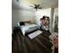Bedroom with a ceiling fan, pink accents, and dark wood flooring at 5681 Captain Kidd Rd, Hollywood, SC 29449