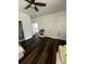Bedroom featuring dark wood floors, white trim, a ceiling fan, and multiple doorways with a view to the upstairs landing at 5681 Captain Kidd Rd, Hollywood, SC 29449