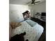 Bright bedroom with floral bedding, ceiling fan, and closet space at 5681 Captain Kidd Rd, Hollywood, SC 29449