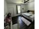 Bedroom featuring dark wood floors, a window, and pink bed with vanity at 5681 Captain Kidd Rd, Hollywood, SC 29449