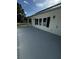 Exterior view of a spacious deck with blue sky and surrounding mature trees at 5681 Captain Kidd Rd, Hollywood, SC 29449