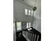 Bright entryway features dark wood floors and staircase with large windows providing ample natural light at 5681 Captain Kidd Rd, Hollywood, SC 29449