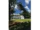 Stately two-story home featuring a white facade, double balconies, a well-maintained lawn, and an attached two-car garage at 5681 Captain Kidd Rd, Hollywood, SC 29449