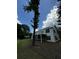 Exterior view of the home showing the deck, screened porch, and mature trees providing shade in the yard at 5681 Captain Kidd Rd, Hollywood, SC 29449