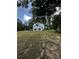 Exterior view of the home showing the well maintained yard, metal roof, and black fencing at 5681 Captain Kidd Rd, Hollywood, SC 29449