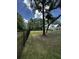 Exterior side view of a well maintained home with a black fence and mature trees surrounding the property at 5681 Captain Kidd Rd, Hollywood, SC 29449
