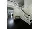 Stairway features wainscotting, dark wood floors, and natural light from the front entry at 5681 Captain Kidd Rd, Hollywood, SC 29449