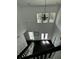 Bright, two-story foyer featuring a decorative chandelier, natural light, and hardwood floors at 5681 Captain Kidd Rd, Hollywood, SC 29449