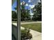 View of the front yard showing the gravel driveway, landscaping, black fencing, and a partial view of the home at 5681 Captain Kidd Rd, Hollywood, SC 29449