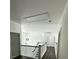 Hallway with staircase, modern lighting, and white railings at 5681 Captain Kidd Rd, Hollywood, SC 29449