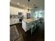 Modern kitchen featuring white cabinets, granite countertops, and seating at the island at 5681 Captain Kidd Rd, Hollywood, SC 29449