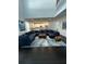 Spacious living room featuring a sectional sofa, kitchen access, and modern decor at 5681 Captain Kidd Rd, Hollywood, SC 29449