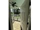 View from inside home looking out onto a covered porch with a rocking chair and backyard at 5681 Captain Kidd Rd, Hollywood, SC 29449
