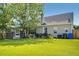 Spacious backyard with lush lawn, mature trees, and a screened porch, perfect for outdoor living and entertaining at 6159 Fieldstone Cir, Charleston, SC 29414