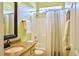 Clean bathroom features a shower-tub combo with white curtain, a granite vanity and plenty of light at 6159 Fieldstone Cir, Charleston, SC 29414