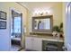 Bright bathroom featuring a vanity with granite countertops and a tiled shower with bench at 6159 Fieldstone Cir, Charleston, SC 29414